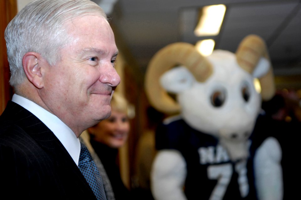 US Navy 081204-N-2855B-048 Secretary of Defense Robert M. Gates smiles as the U.S. Naval Academy Band and cheerleaders stop outside his office during their annual pep rally through the halls of the Pentagon