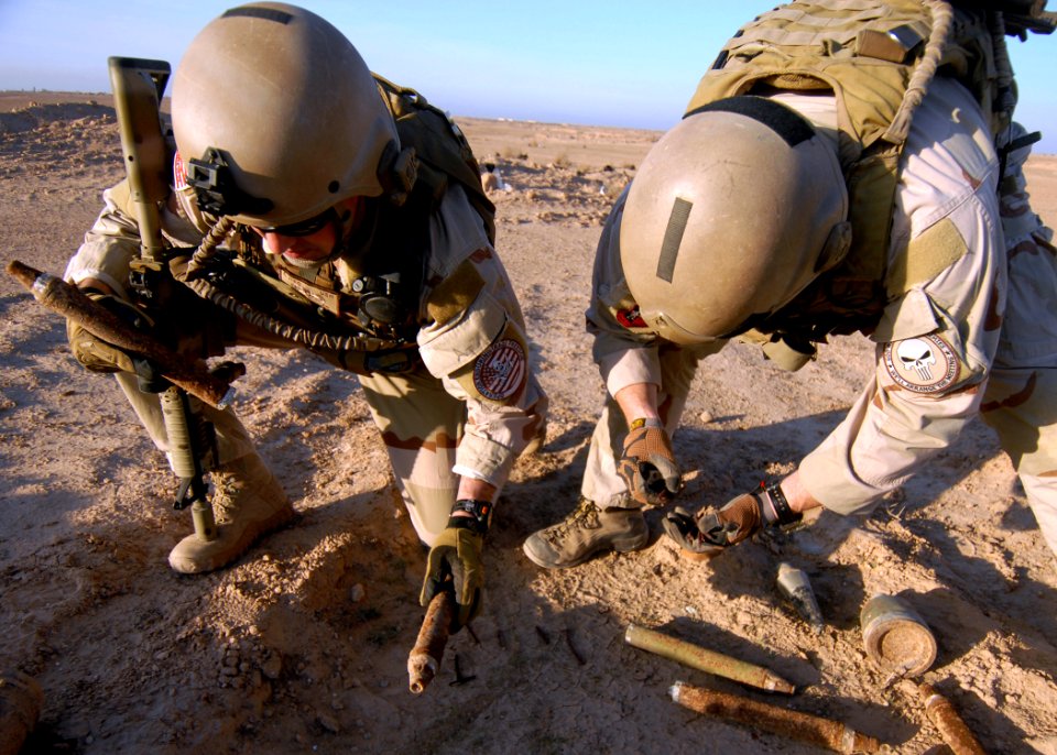 US Navy 081205-N-6278K-046 Explosive Ordnance Disposal Technician 1st Class Aaron Ritter, left, and Explosive Ordnance Disposal Technicians 1st Class Ben Jones gather unexploded ordnance for disposal