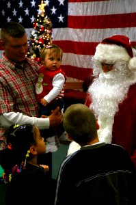 US Navy 081211-N-7367K-006 Construction Mechanic 3rd Class Robert Davies introduces his daughter to Santa Claus