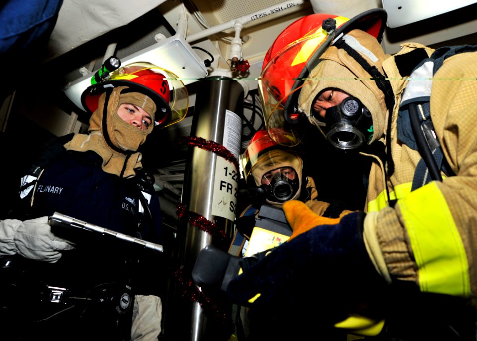 US Navy 101215-N-6499D-052 ulinary Specialist 2nd Class Korhy Flanary, left, Culinary Specialist Seaman Recruit Paul Osis, and Damage Controlman 3r