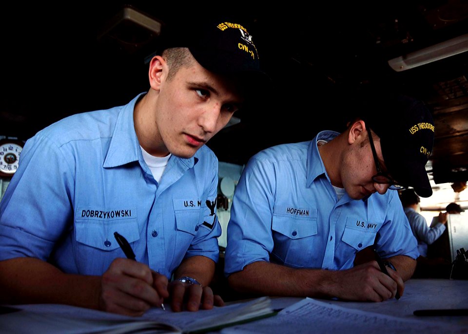 US Navy 081209-N-7571S-004 Quartermaster 3rd Class Andrew Dobrzykowski and Quartermaster Seaman Erich Hoffman plot the ship's course on the navigation bridge aboard the Nimitz-class aircraft carrier USS Theodore Roosevelt (CVN