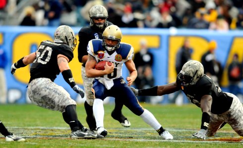 US Navy 081206-N-5345W-819 U.S. Naval Academy quarterback Kapo-Noa Kaheaku-Enhada (^10) scrambles for a first down during the first half of the 109th Army-Navy college football game at Lincoln Financial Field in Philadelphia