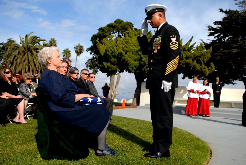 US Navy 081208-N-9818V-521 Master Chief Petty Officer of the Navy Joe R. Campa Jr. presents Carol Crow the flag from her husband's casket during funeral services for MCPON Crow