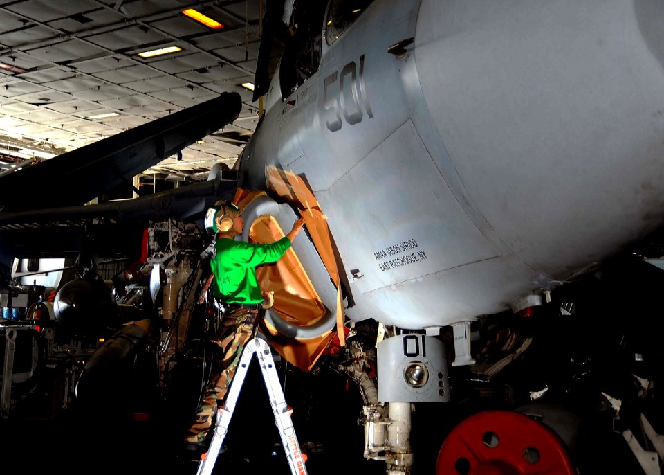 US Navy 081213-N-7571S-003 Aviation Structural Mechanic 1st Class Keum Bird masks the intake of an EA-6B Prowler