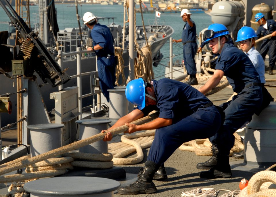 US Navy 081209-N-9134V-026 Sailors heave a mooring line