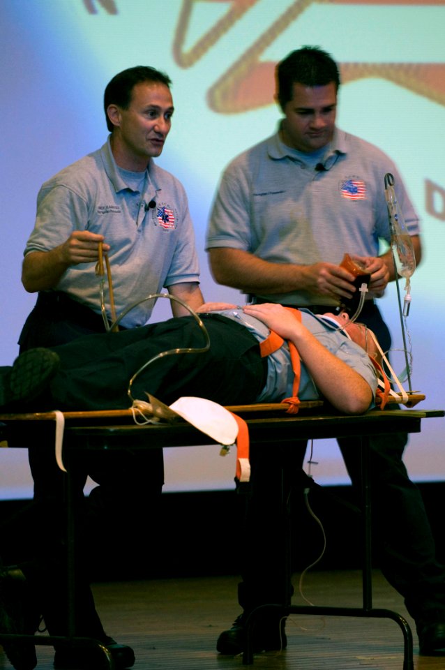US Navy 081210-N-5253W-002 Vince Easevoli, left, and Joseph McCluan, both firefighter-paramedics and members of the Stay Alive From Education (S.A.F.E.) program, demonstrate consequences of poor decision making on a volunteer a