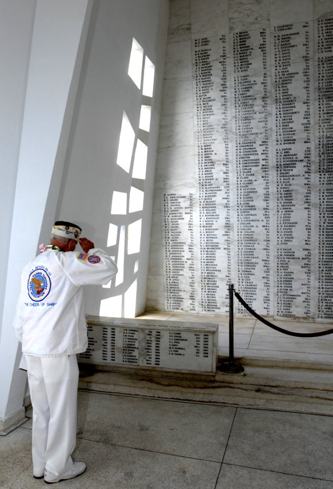 US Navy 081207-N-0535P-215 Woody Derby, a survivor of the attack on Pearl Harbor, salutes the names of the deceased at the USS Arizona Memorial
