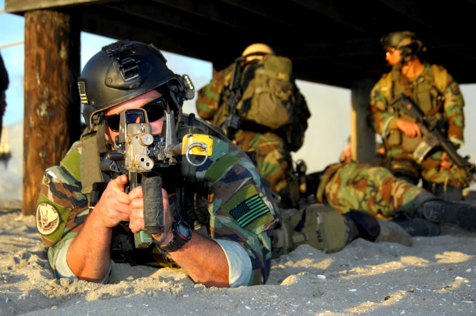 US Navy 081210-N-5366K-098 A Special Warfare Combatant-craft Crewman keeps a look out while his teammates treat an injured teammate during a casualty assistance and evacuation scenario