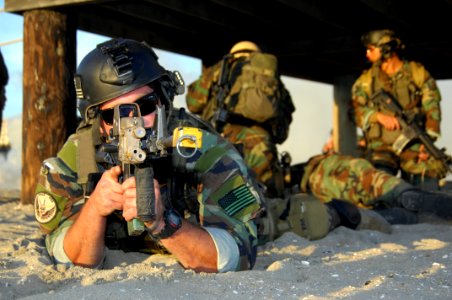 US Navy 081210-N-5366K-098 A Special Warfare Combatant-craft Crewman keeps a look out while his teammates treat an injured teammate during a casualty assistance and evacuation scenario