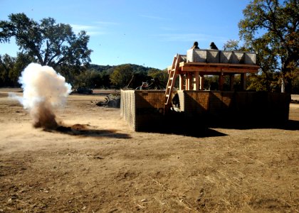 US Navy 081210-N-9584N-032 An exploding artillery round simulator marks the start of the Naval Mobile Construction Battalion (NMCB) 5 mass casualty drill during a field training exercise at Fort Hunter Liggett photo