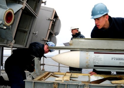 US Navy 110126-N-5538K-156 Fire Controlman 2nd Class Jonathan J. Connor, right, loads a RIM-7P Sea Sparrow surface-to-air missile into a launcher a