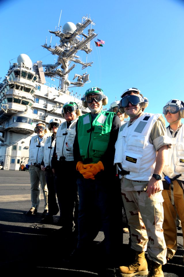 US Navy 081211-N-7571S-107 Afghanistan President Hamid Karzai, left, and Vice Adm. Bill Gortney, commander of U.S. Naval Forces Central Command, pause for a on the flight deck of the Nimitz-class aircraft carrier USS Theodore R