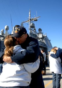 US Navy 110307-N-5292M-018 Fire Controlman 2nd Class Daniel Hoffman hugs his wife before boarding the guided-missile cruiser USS Monterey (CG 61)