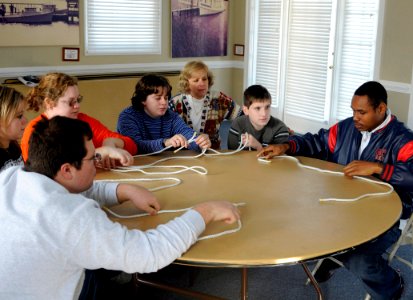 US Navy 081212-N-1831S-062 Boatswain's Mate 2nd class Jamie Marriott shows the students from the LifeSkills Learning Center how to tie a square knot