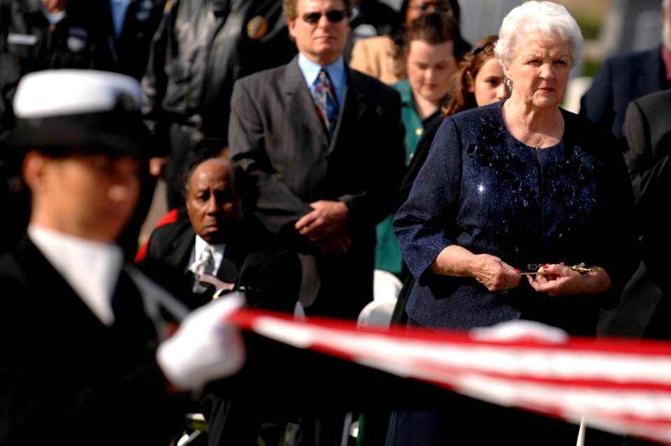 US Navy 081208-N-9818V-432 Carol Crow watches as the flag from MCPON Thomas S. Crow's casket is folded during his funeral services