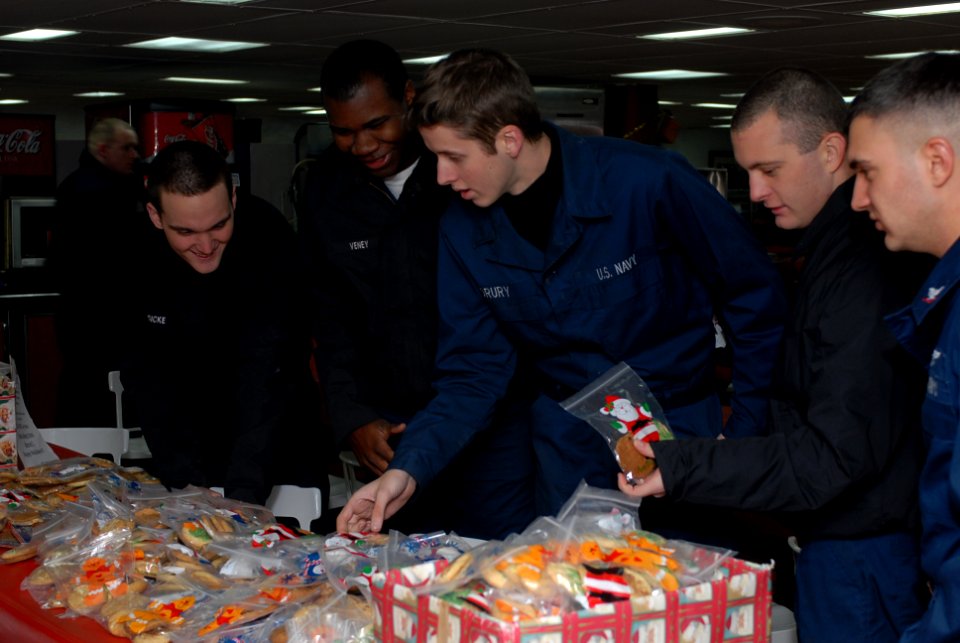 US Navy 081219-N-5215E-013 Sailors receive bags of cookies from United Service Organization volunteers