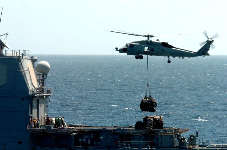 US Navy 081217-N-3931M-307 An SH-60 Sea Hawk delivers supplies to the guided missile cruiser USS Vella Gulf (CG 72)