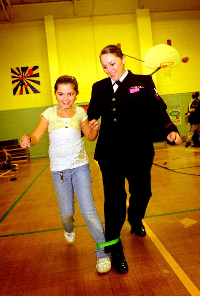 US Navy 081210-N-5345W-023 Aviation Maintenance Administrationman 2nd Class Amber Gamez and her mentee hop their way to victory in a three-legged race