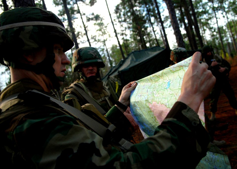 US Navy 081215-N-3674H-056 Lt. Bob Kendall double checks the route for a patrol through the woods of Camp Shelby