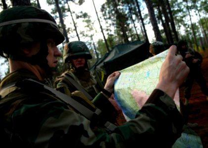 US Navy 081215-N-3674H-056 Lt. Bob Kendall double checks the route for a patrol through the woods of Camp Shelby