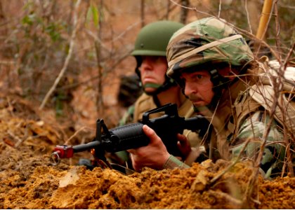 US Navy 081215-N-3674H-194 Construcion Mechanic Senior Chief Matthew Aninos keeps watch in a fighting position at Camp Shelby