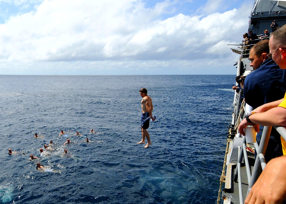 US Navy 081216-N-1082Z-065 Gunner's Mate 2nd Class Joshua McMullen jumps from USS Vella Gulf (CG 72) during a swim call