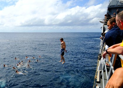 US Navy 081216-N-1082Z-065 Gunner's Mate 2nd Class Joshua McMullen jumps from USS Vella Gulf (CG 72) during a swim call