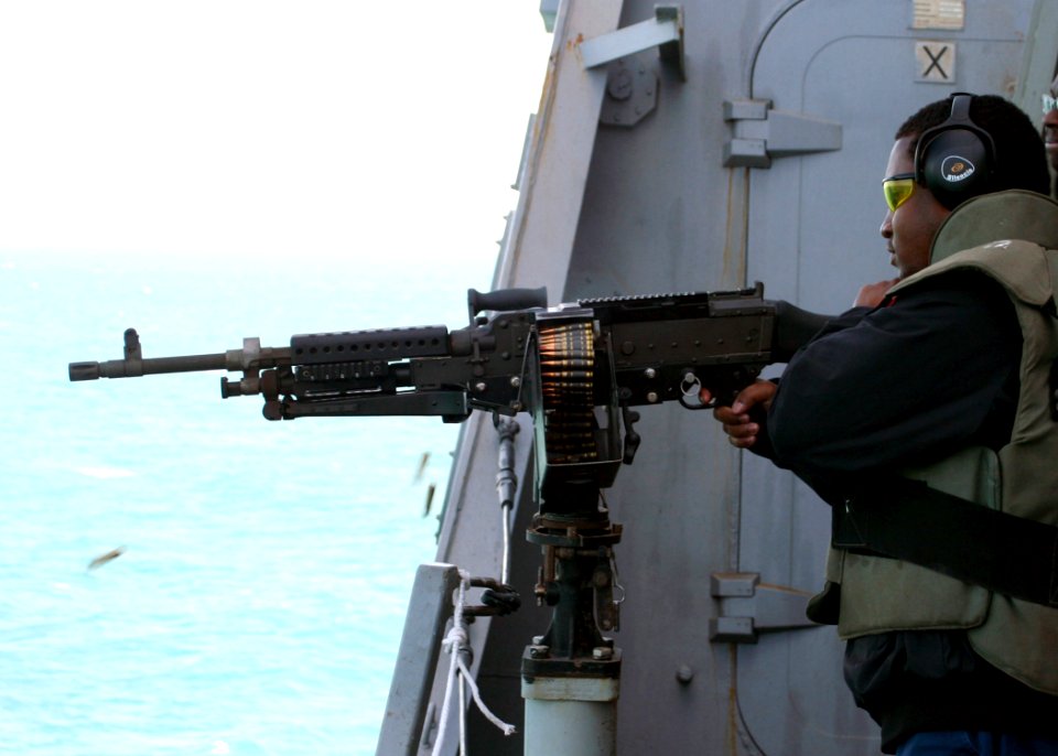 US Navy 081216-N-6764G-170 Gunner's Mate 1st Class Montrell Dorsey fires an M240B automatic weapon during a live-fire training exercise aboard the amphibious transport dock ship USS San Antonio (LPD 17)