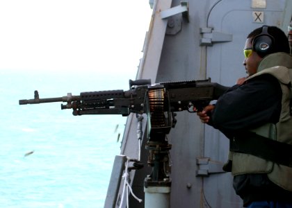 US Navy 081216-N-6764G-170 Gunner's Mate 1st Class Montrell Dorsey fires an M240B automatic weapon during a live-fire training exercise aboard the amphibious transport dock ship USS San Antonio (LPD 17)