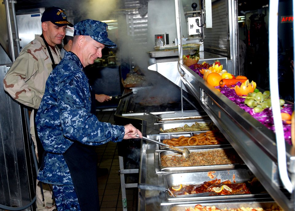 US Navy 081219-N-0803S-011 Master Chief Petty Officer of the Navy (MCPON) Rick West prepares to serve lunch to Sailors and Marines