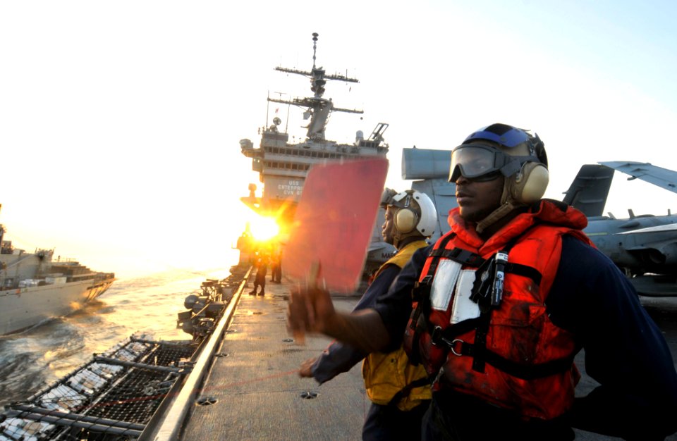 US Navy 110323-N-3852A-055 Seaman Deremy Walker signals for supplies to USNS Arctic (T-AOE 8) during an underway replenishment
