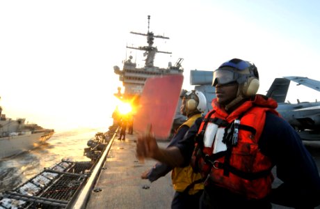 US Navy 110323-N-3852A-055 Seaman Deremy Walker signals for supplies to USNS Arctic (T-AOE 8) during an underway replenishment