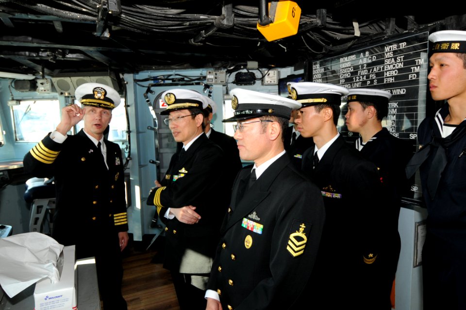 US Navy 081219-N-3262C-015 Capt. Thom W. Burke iscusses different aspects of the bridge with sailors from the Japan Maritime Self-Defense Force ship Tachikaze (DDG 168)