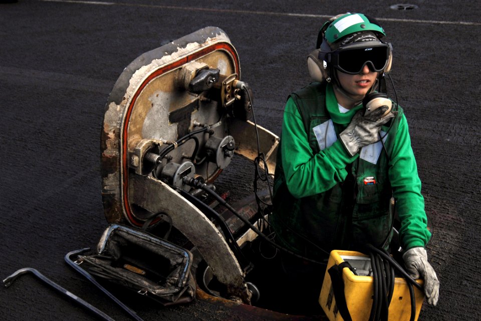 US Navy 081229-N-8822R-059 Aviation Boatswain's Mate (Equipment) Airman Melissa Pyle conducts a communications check on the flight deck of the aircraft carrier USS Theodore Roosevelt (CVN 71)