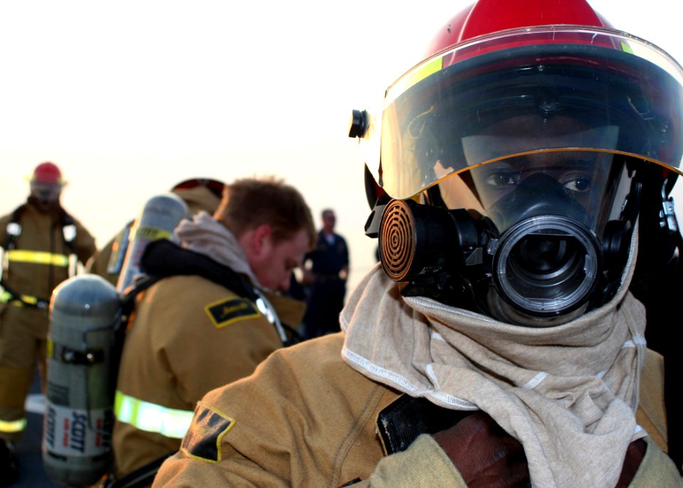 US Navy 081214-N-6764G-213 Sailors don fire fighting ensembles during a damage control olympics aboard the amphibious transport dock ship USS San Antonio (LPD 17)