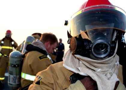 US Navy 081214-N-6764G-213 Sailors don fire fighting ensembles during a damage control olympics aboard the amphibious transport dock ship USS San Antonio (LPD 17)