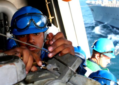 US Navy 081213-N-6764G-075 Boatswain's Mate Seaman Winfred McCollum secures line aboard the amphibious transport dock ship USS San Antonio (LPD 17) during an underway replenishment with the fleet replenishment oiler USNS Larami