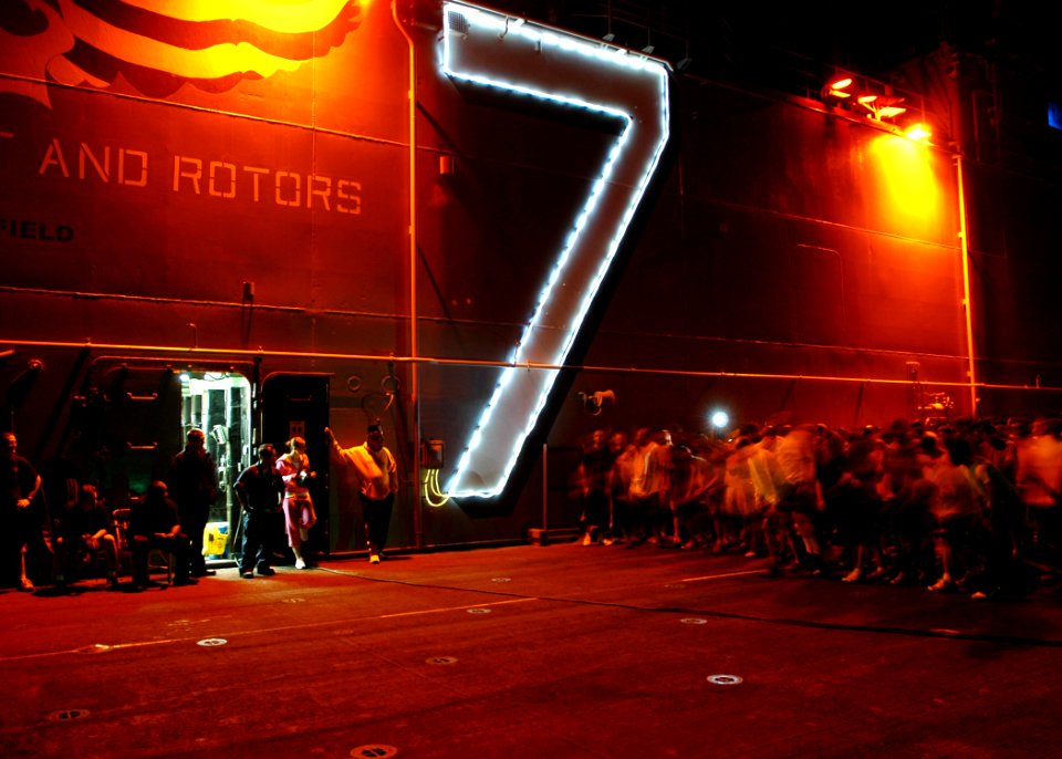 US Navy 090101-N-5681S-037 Sailors participate in a New Years Day 5k run on the flight deck of the multi-purpose amphibious assault ship USS Iwo Jima (LHD 7)