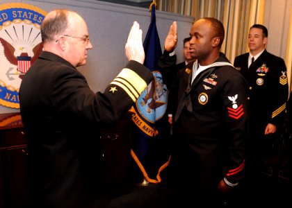 US Navy 090106-N-7948R-004 Vice Adm. John C. Harvey, Jr. meritoriously promotes Electricians Mate 1st Class Curtis Bembow