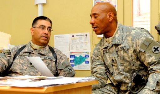 US Navy 081222-N-0000X-001 Army Lt. Col. Leo Griego, left, from Las Vegas, N.M., discusses ways to improve the accountability process of Afghanistan National Police assets with new command 1st Sgt. Senior Chief Ernest Edwards