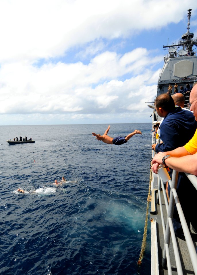 US Navy 081216-N-1082Z-049 Cryptologic Technician (Technical) 2nd Class Jason Nicholas jumps from USS Vella Gulf (CG 72) during a swim call