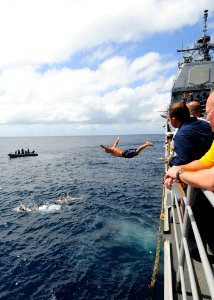 US Navy 081216-N-1082Z-049 Cryptologic Technician (Technical) 2nd Class Jason Nicholas jumps from USS Vella Gulf (CG 72) during a swim call