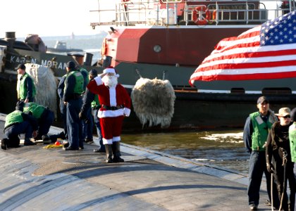US Navy 081223-N-7705S-059 Santa Claus salutes the national ensign aboard USS Boise (SSN 764) following the submarine's return to Naval Station Norfolk