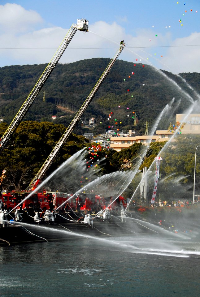US Navy 090106-N-0807W-656 Firefighters from the Sasebo Fire Department are joined by the Fleet Activities Sasebo fire department in performing a mass fire hose demonstration during the Sasebo Fire Department's New Year's Parad