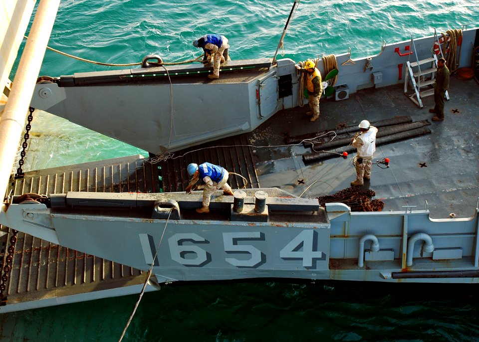 US Navy 090107-N-5681S-018 A landing craft utility conducts well deck operations with the multi-purpose amphibious assault ship USS Iwo Jima (LHD 7)