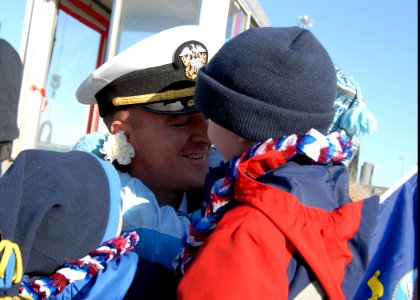 US Navy 081223-N-7705S-093 Lt. Cmdr Brad Terry embraces his children for the first time in six months after returning to Naval Station Norfolk