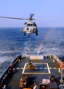 US Navy 081227-N-1082Z-022 An SH-60B Sea Hawk lowers pallets onto the fantail of the Military Sealift Command fleet ocean tug USNS Catawba (T-ATF 168)