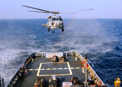 US Navy 081227-N-1082Z-032 An SH-60B Sea Hawk lowers pallets onto the fantail of the Military Sealift Command fleet ocean tug USNS Catawba (T-ATF 168)
