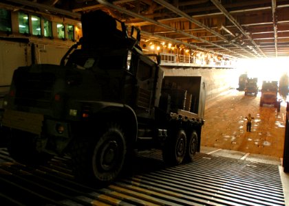 US Navy 081228-N-4236E-122 Boatswain's Mate 2nd Class David Murphy directs Marine vehicles to a landing craft air cushion