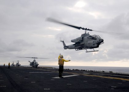 US Navy 110411-N-SO729-255 An AH-1W Super Cobra helicopter takes off from USS Essex (LHD 2)